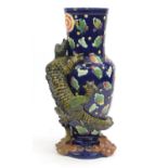 Large George Jones Majolica vase, decorated in relief with a dragon, hand painted with clouds,