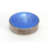 Continental silver and guilloche enamel pill box, the lid enamelled with a cherub, signed G