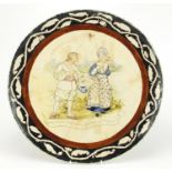 Minton's pottery charger hand painted with two figures before a town, within a foliate border,