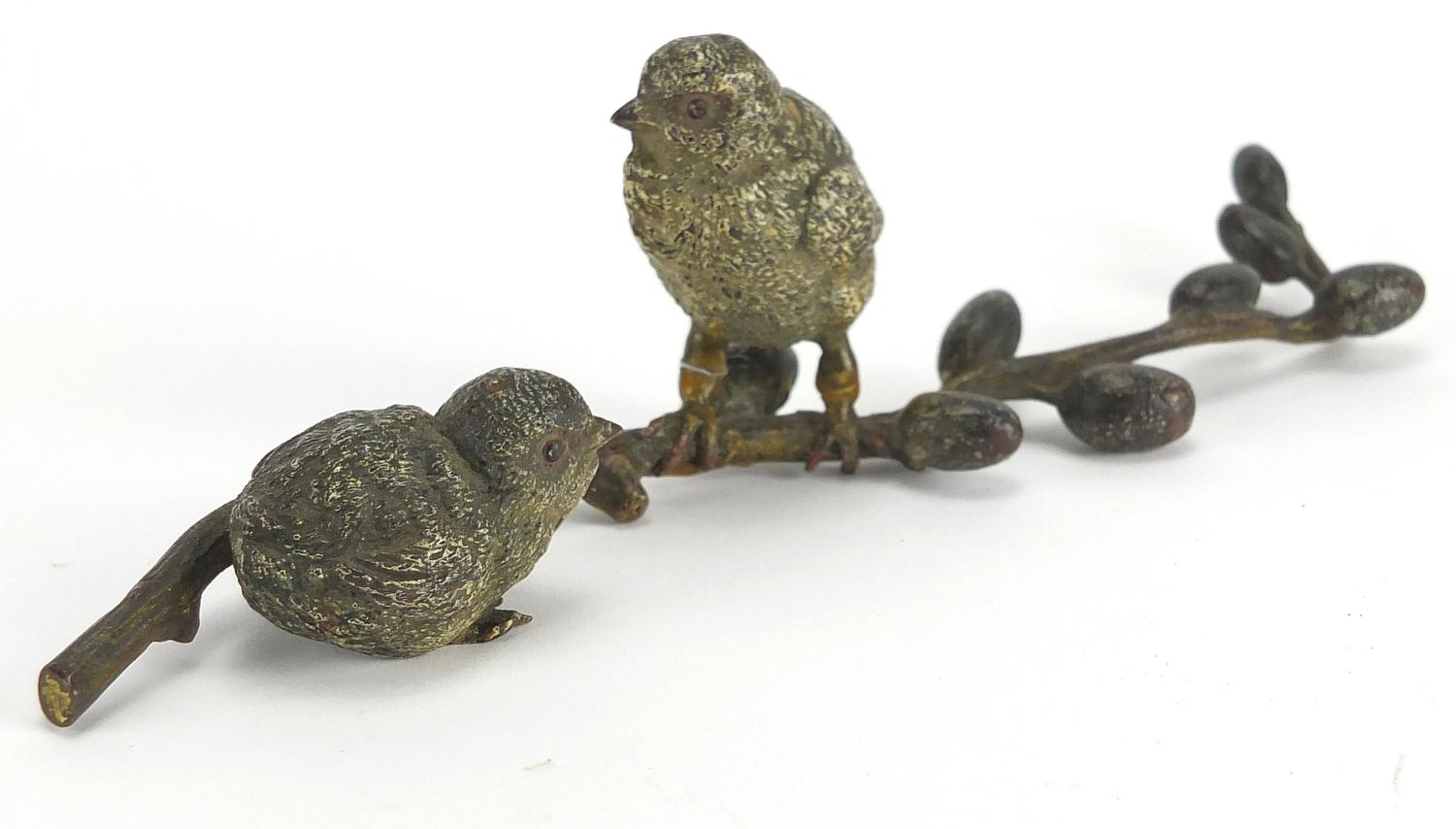 Austrian cold painted bronze group of two birds on a branch, stamped Geschutzt to the base, 20cm