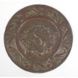 Large Arts & Crafts copper charger embossed with stylised dolphins, 64cm in diameter Further