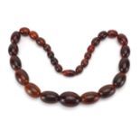 Horn bead necklace, possibly rhino horn, the largest bead 3.5cm wide, approximate weight 178g