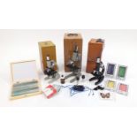 Three microscopes together with a collection of prepared slides, all with cases Further condition