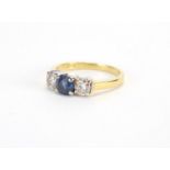18ct gold Sapphire and Diamond three stone ring, size J, approximate weight 3.1g The Sapphire is