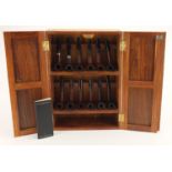 Twelve Dunhill smoking pipes housed in a hardwood pipe rack, including Shell Briar, Bruyere and Root