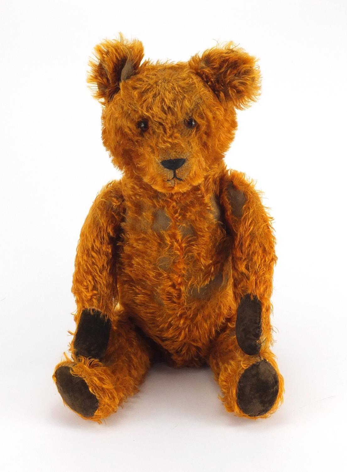 Vintage golden straw filled teddy bear with jointed limbs and beaded glass eyes, 65cm high Further