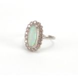 18ct white gold opal and diamond ring, size R, approximate weight 3.9g Further condition reports can