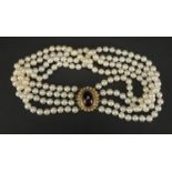Four row pearl necklace with 9ct gold cabochon garnet clasp, 40cm in length, approximate weight