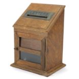 Edwardian oak letter box with hinged front having a brass 'Letters' flap above a glass panel, 30cm