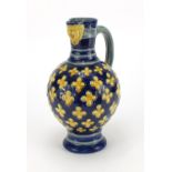 Minton's Majolica jug with mask spout hand painted with flowers, impressed factory marks and