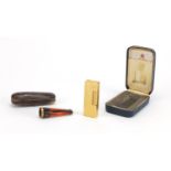 Gold plated Dunhill pocket lighter and cheroot with gold coloured metal mount, both with fitted