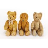 Three vintage golden teddy bear's each with jointed limbs and beaded eyes, the largest 22cm high