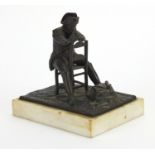 19th century bronze study of Napoleon reading plans of The Battle of Waterloo, raised on a white