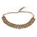 Indian? gilt metal necklace set with clear red and green stones, 22.5cm wide Further condition