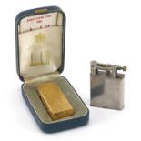 Two Dunhill pocket lighters including a gold plated example with engine turned decoration and fitted