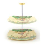 Clarice Cliff Bizarre, two tier cake stand hand painted in the Aurea pattern, factory marks to the