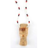 African beadwork necklace with carved bone figural pendant, 36cm in length : For further Condition