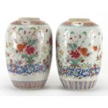 Pair of Chinese porcelain jars, each finely hand painted in the famille rose palette with flowers