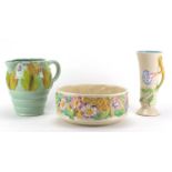 Clarice Cliff Newport pottery bowl, jug and vase, each hand painted with flowers, the largest 23cm