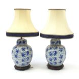 Pair of Chinese blue and white porcelain jar lamps hand painted with fish, each with a silk lined