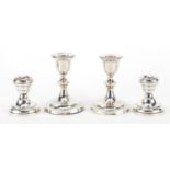 Two pairs of silver dwarf candlesticks, the largest L & S Birmingham 1909, 10.5cm high,