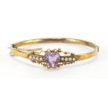 Victorian unmarked gold love heart amethyst and seed pearl bangle, 6cm x 5.5cm, approximate weight