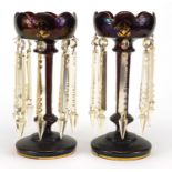 Pair of 19th century red glass lustres with gilt decoration and cut glass drops, each 28cm high :