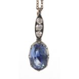 Unmarked white and yellow metal sapphire and diamond pendant, with a white metal necklace, the