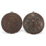 Two Tibetan embossed copper wall hanging plaques both inset with turquoise, each 25.5cm in