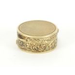 Continental 14ct gold pill box with floral chased decoration, impressed mark around the inside