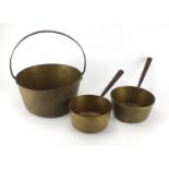 Brass cooking pan and two saucepans with cast iron handles, the largest 38cm high : For further