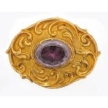 Victorian unmarked gold amethyst brooch with embossed decoration, housed in a F.Ahrends & Co