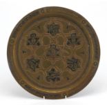 Islamic brass tray with silver and copper inlay, decorated with script and foliate motifs, 34cm in