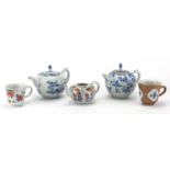 Chinese porcelain comprising three teapots and two cups, one hand painted in the famille rose