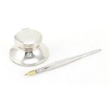 Modern circular silver Capstan inkwell and a silver dip pen, the inkwell 7cm in diameter : For