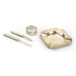 Silver items, two silver bladed Mother of Pearl flanked folding fruit knives, square ashtray and a