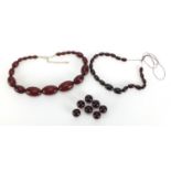 Two cherry amber coloured bead necklaces and a selection of loose beads, the largest bead