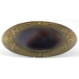 Arts & Crafts oval brass mirror with bevelled plate and embossed Celtic motifs, 61cm x 29cm : For