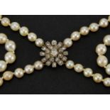 Antique two string pearl necklace with a diamond flower head clasp, 48cm in length, approximate