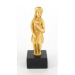 18/19th century Indian Mughal carved ivory figure, raised on black painted square wooden base,