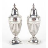 Pair of Victorian silver urn shaped casters, indistinct hallmarks, 8.5cm high, approximate weight