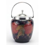 Moorcroft Pomegranate pattern pottery biscuit barrel, with silver mounts and swing handle, impressed