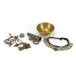 Islamic objects including a silver pill box, engraved brass bowl and three necklaces, the bowl