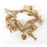 9ct gold charm bracelet with a selection of mostly 9ct gold charms including Brighton Pavilion,