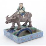 Chinese porcelain boy and a buffalo crossing a bridge brush washer, finely hand painted in the