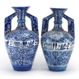 Pair of Middle Eastern pottery vases, each with twin handles, both hand painted with script and