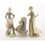 Three Lladro figurines, one of a young girl carrying a basket, the largest 24.5cm high : For further