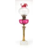 Victorian brass Corinthian column oil lamp with cranberry and frosted etched glass shade, 79cm