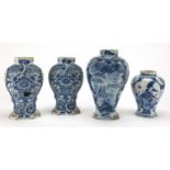 Four antique blue and white Delft vases, one hand painted with a panel of two figures before a town,