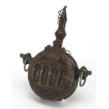 Islamic bronze powder flask, the circular body decorated with a mosque, 20cm high : For further